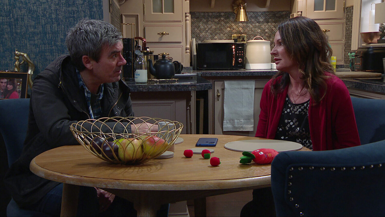 Chas and Cain talking on Emmerdale at the table