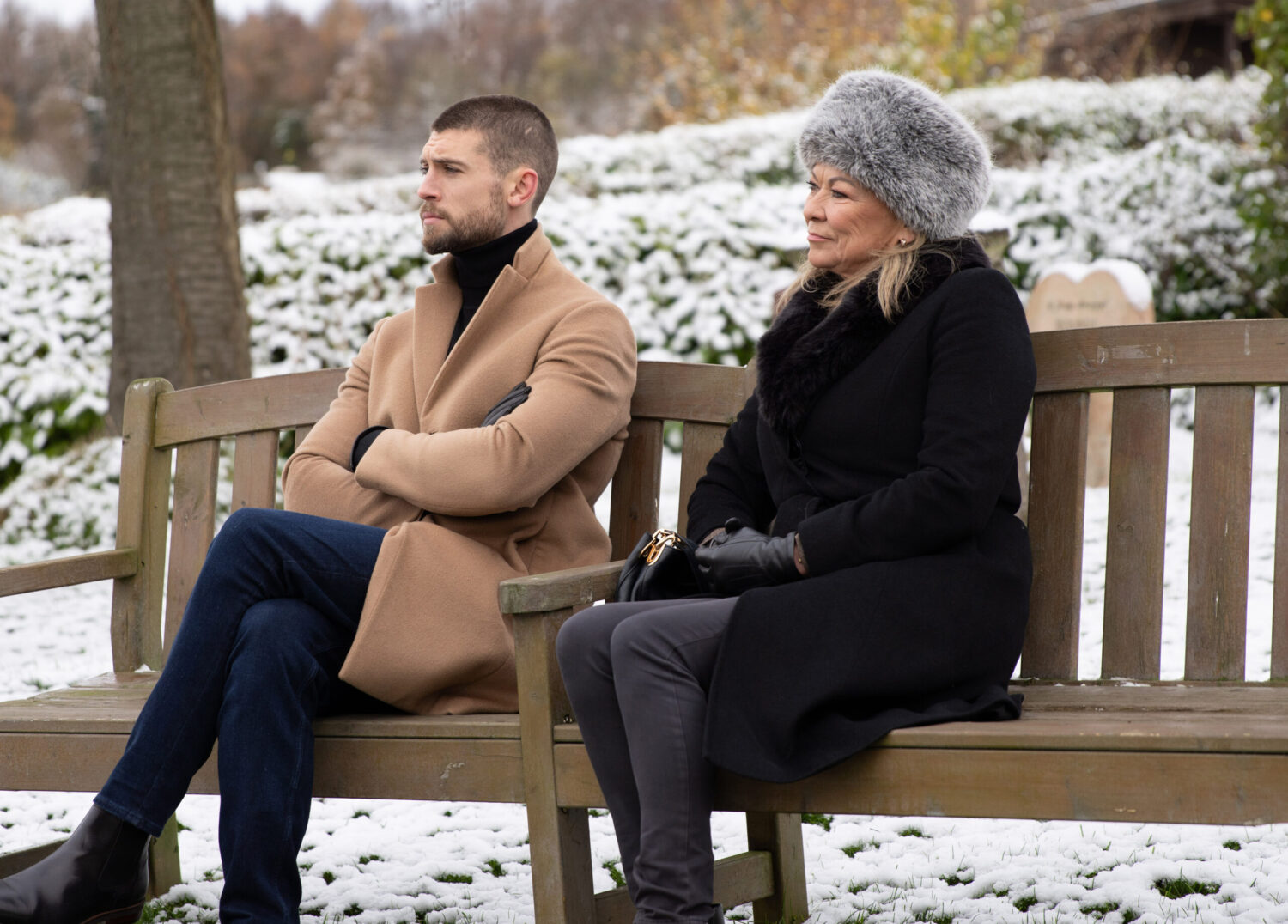 Joe and Kim talking on a bench in the snow