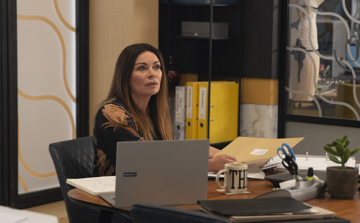 Carla is holding some post in the factory