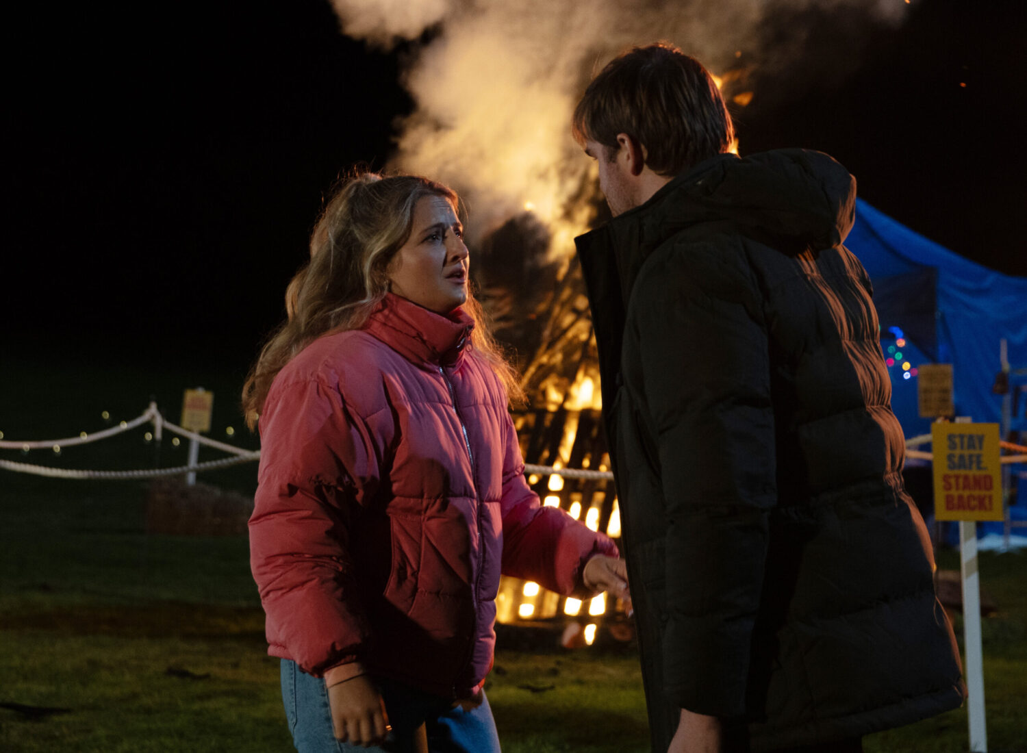 Amelia and Tom are talking at the bonfire in Emmerdale