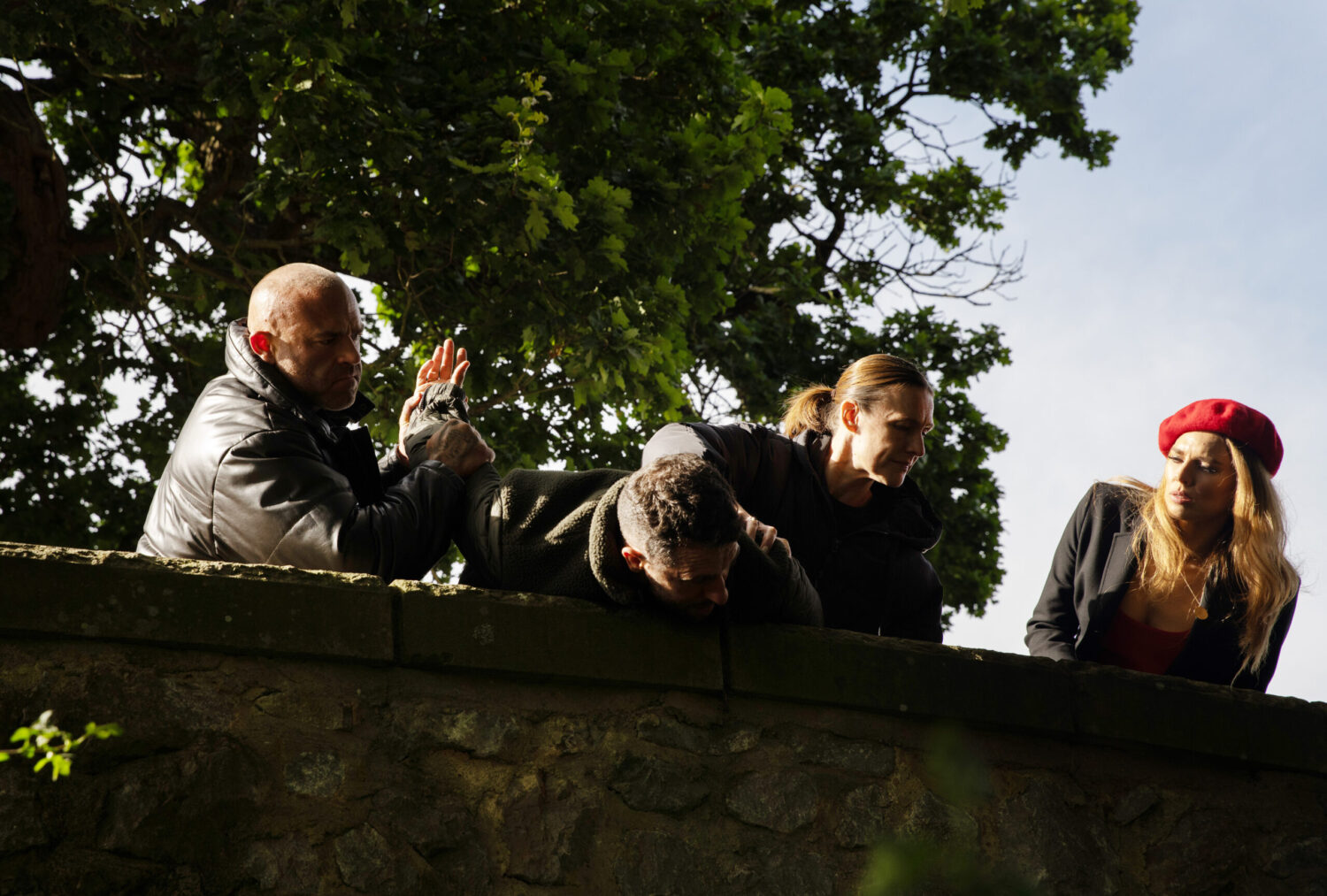 Ross is being threatened over a bridge by Jade and some heavies