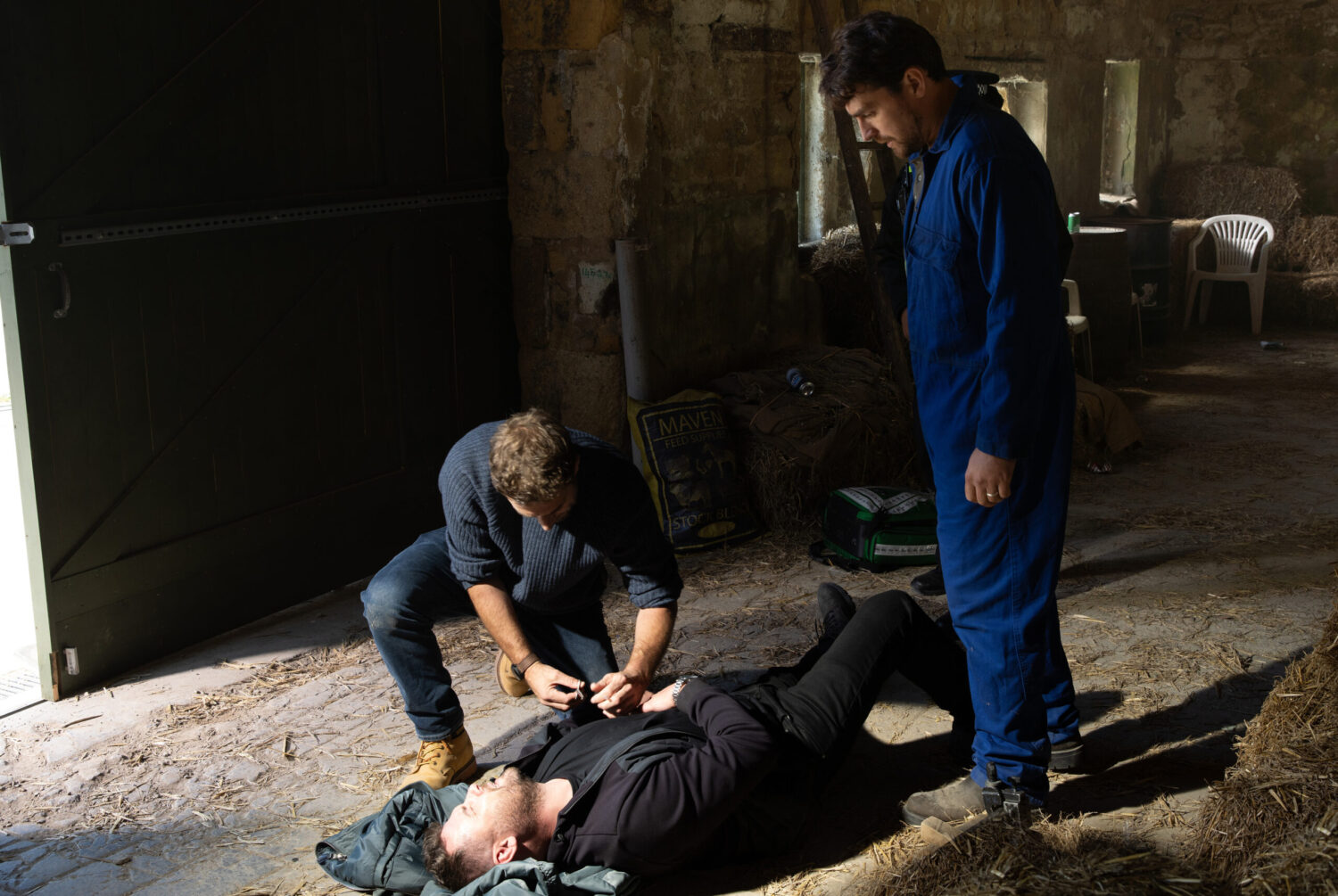 Mack and John are tending to a collapsed Aaron