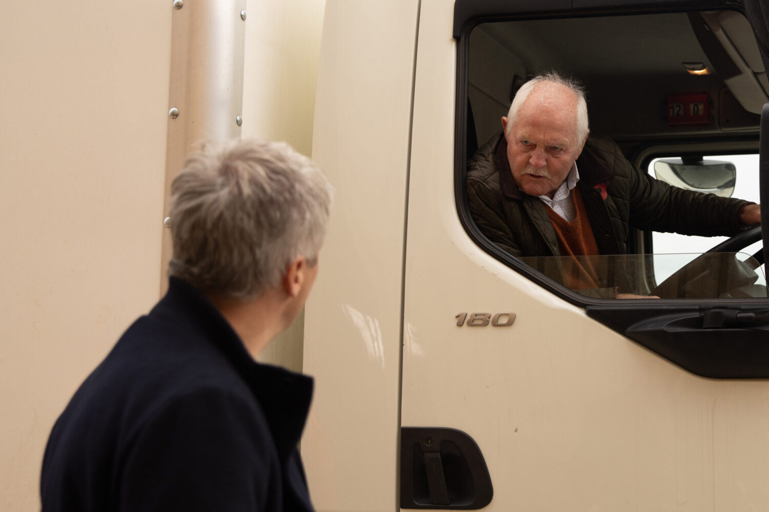 Eric peering out of a lorry at Caleb in Emmerdale