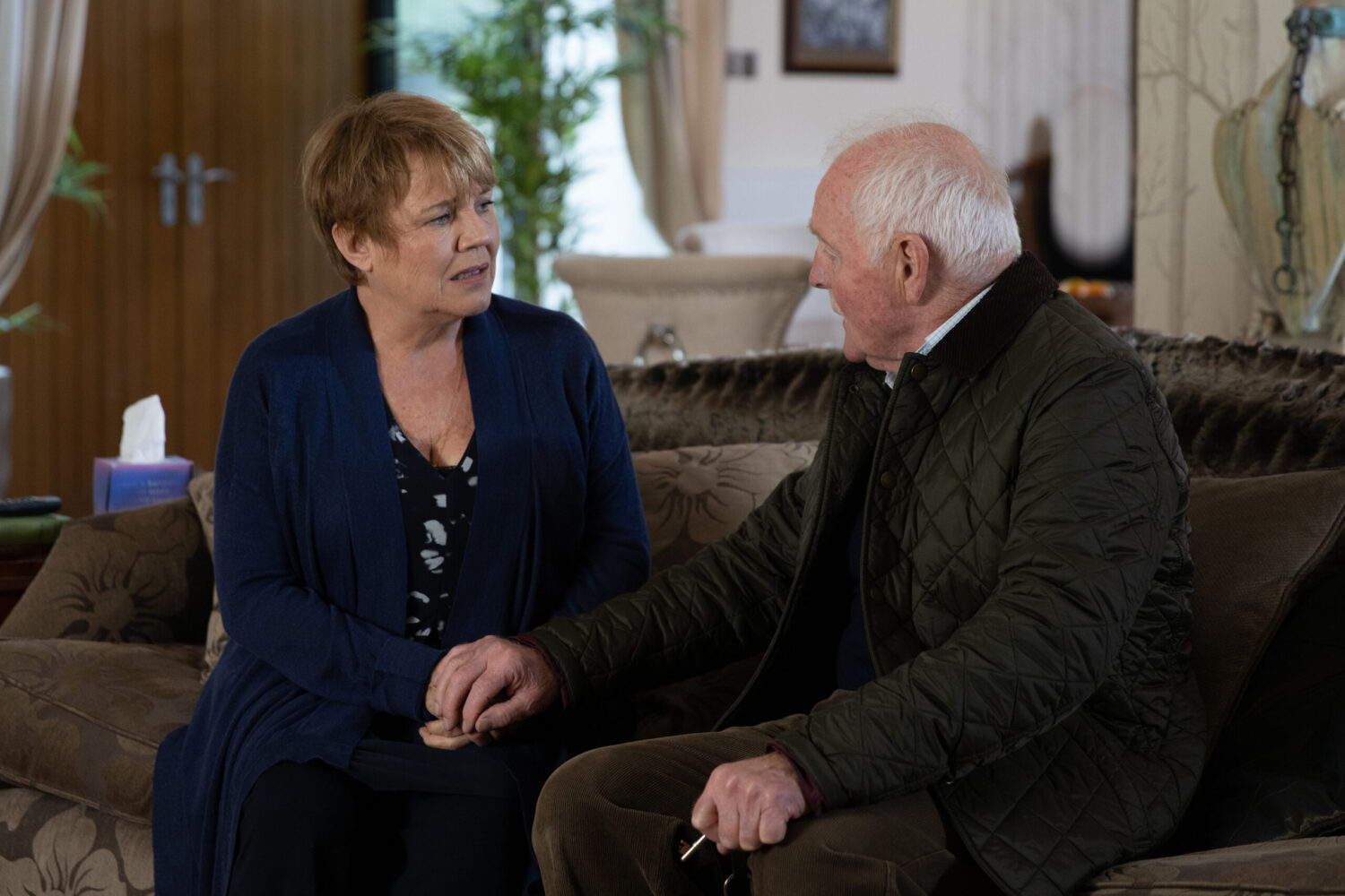 Brenda and Eric talking on the sofa