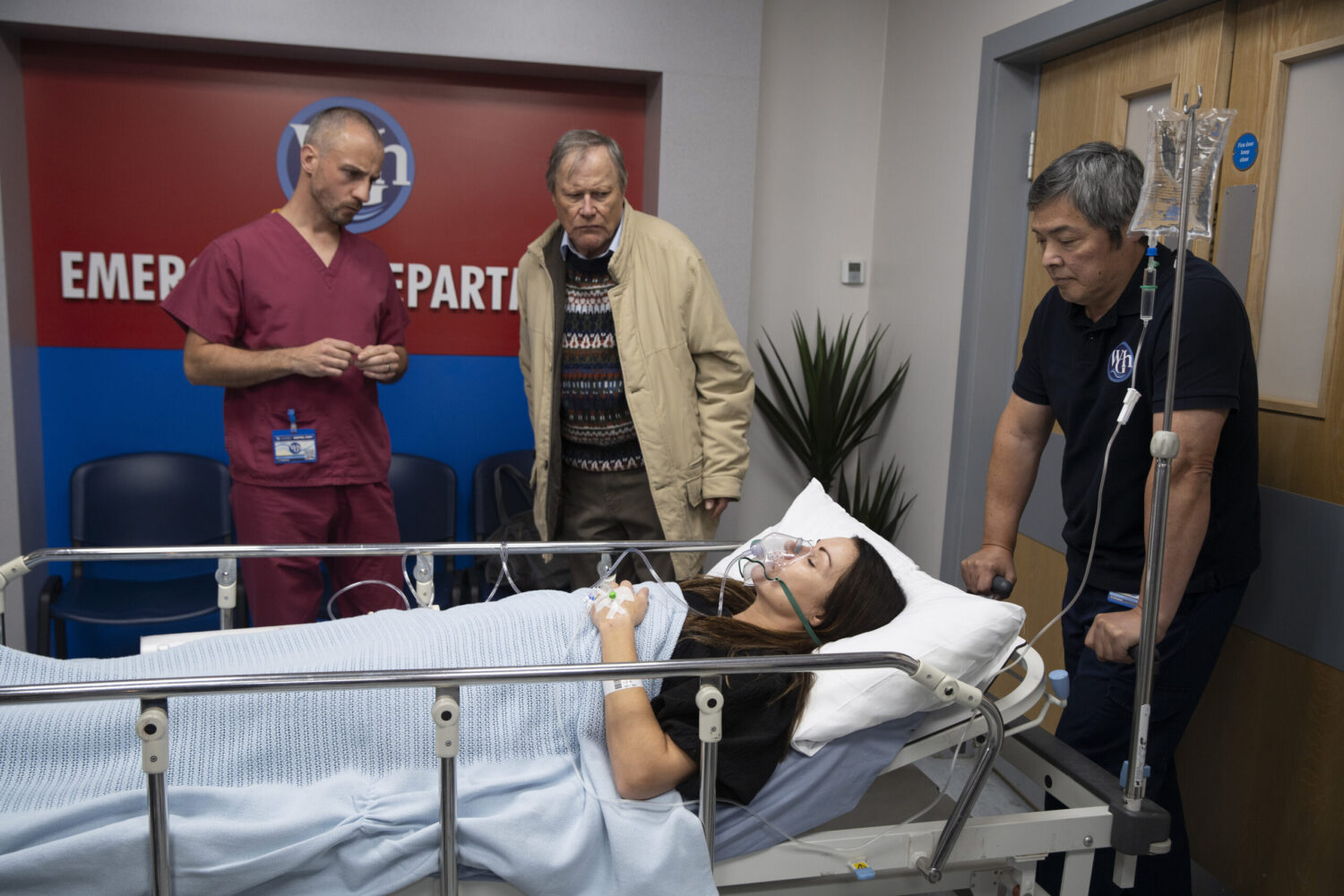Carla on stretcher in hospital bed with Roy