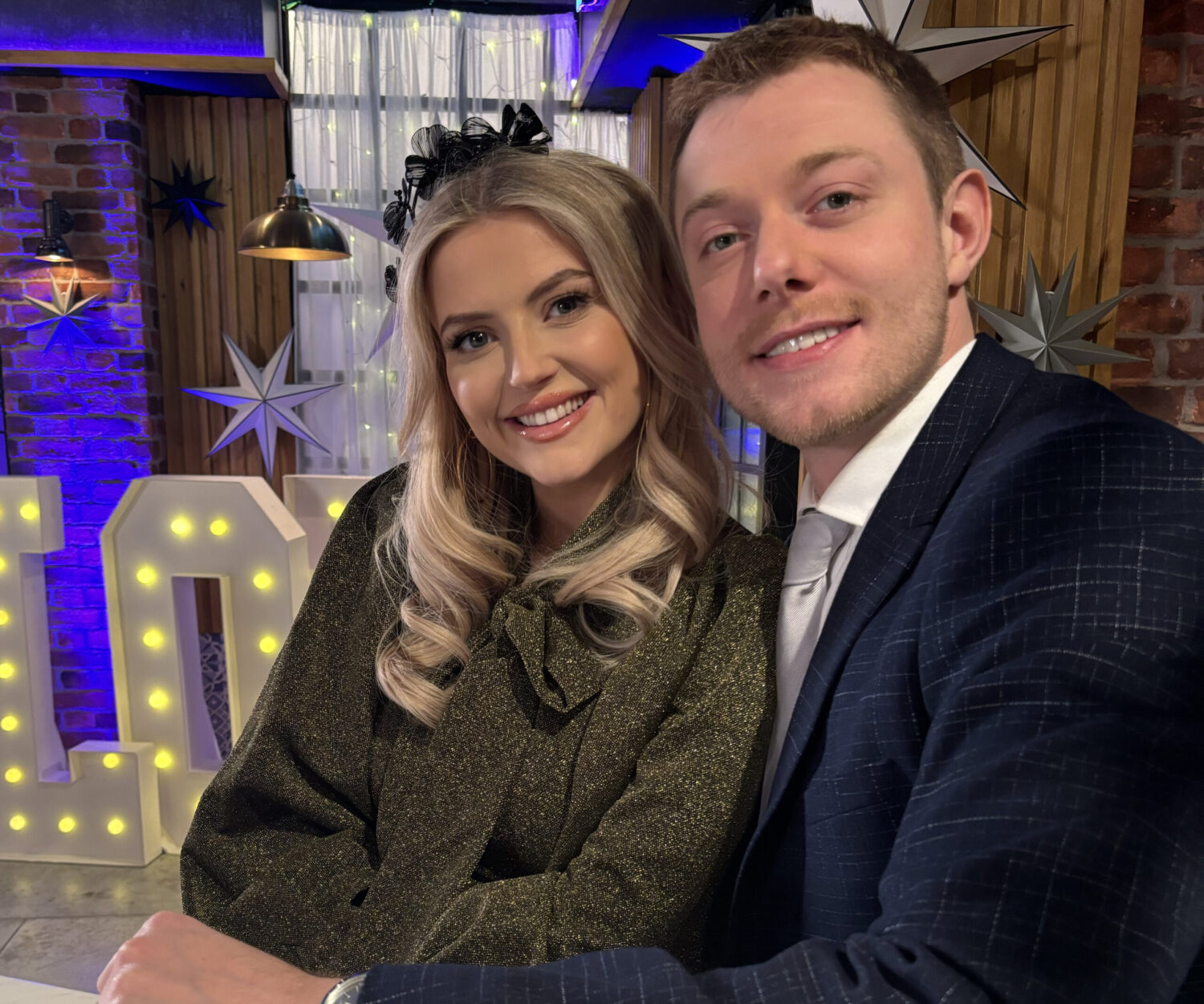 Bethany and Daniel smiling at Gail's wedding