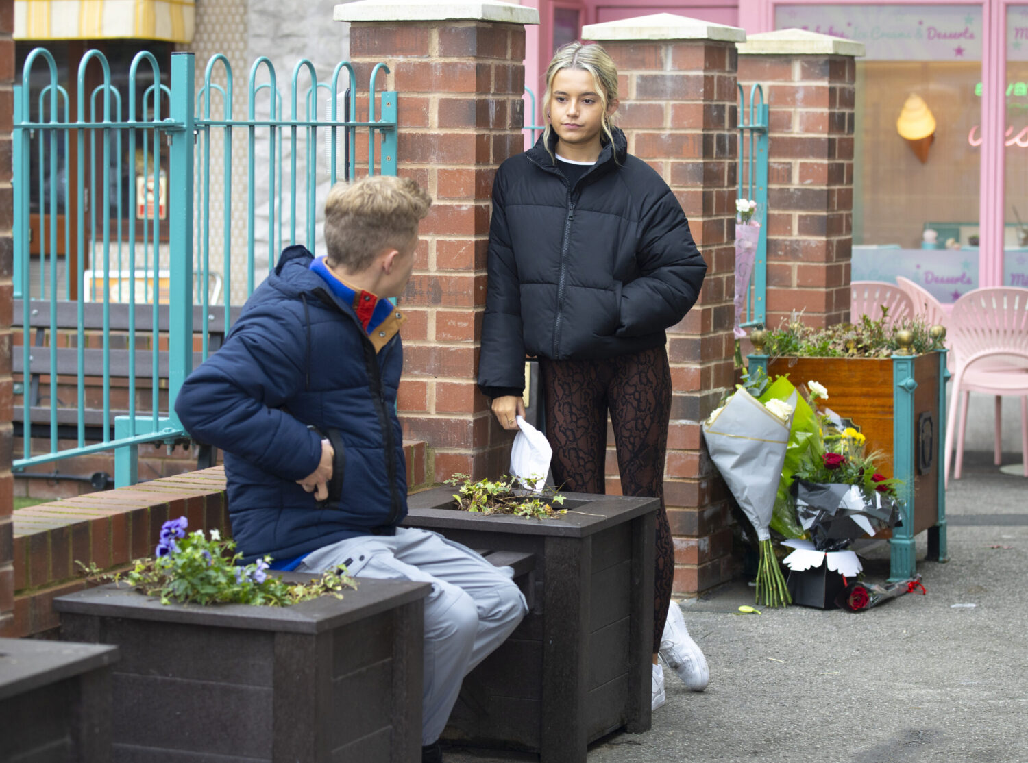 Betsy and Dylan talking at the precinct