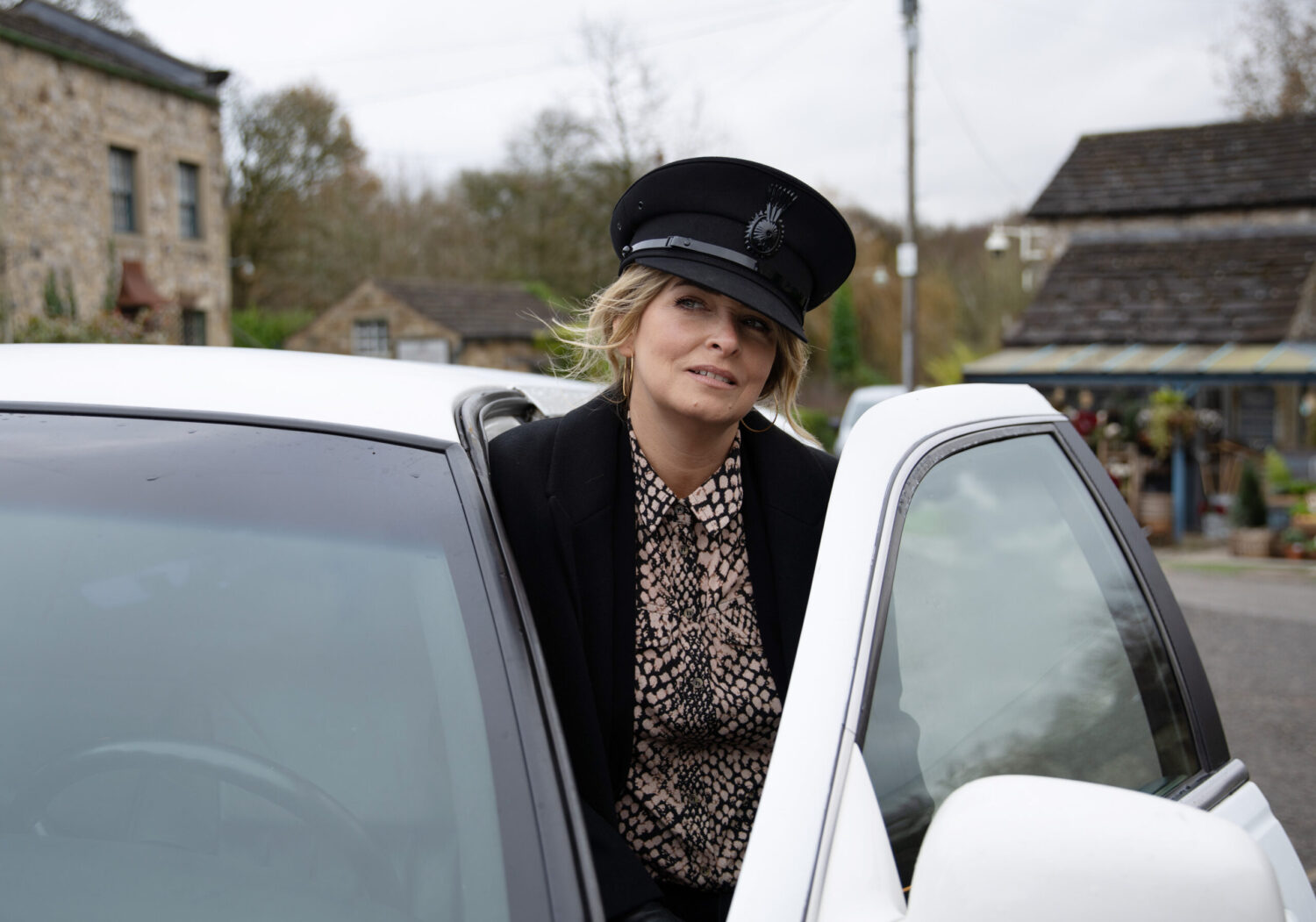 Charity opening the limo door in Emmerdale