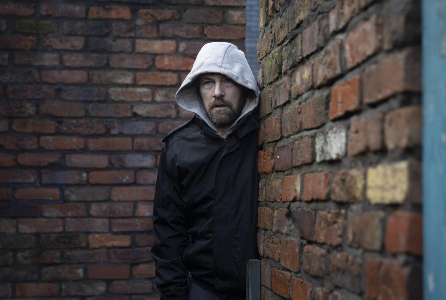 Rob with his hood up in the ginnel